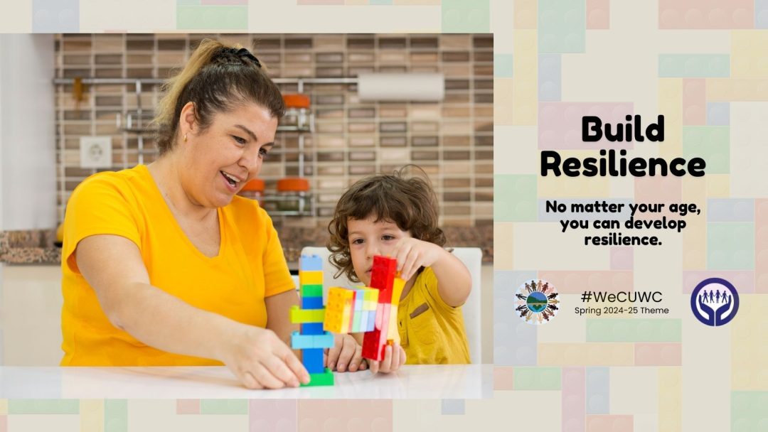 A mother and child build with blocks to visibly demonstrate the theme "Build Resilience"